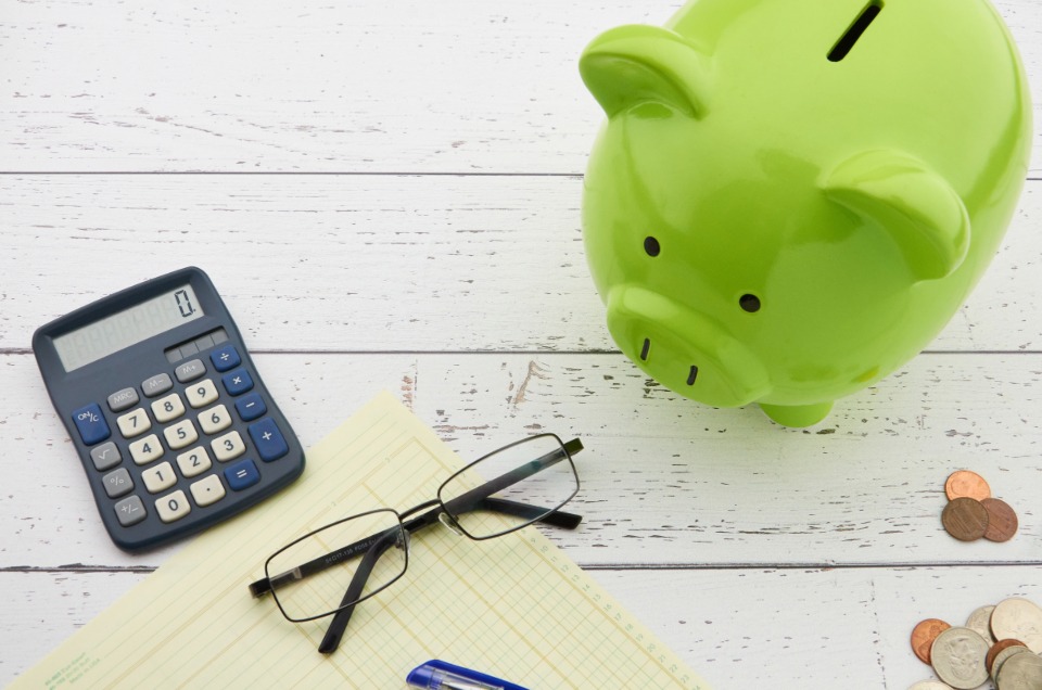 Early Mortgage Payoff Strategies That Work Piggy bank next to a small model house