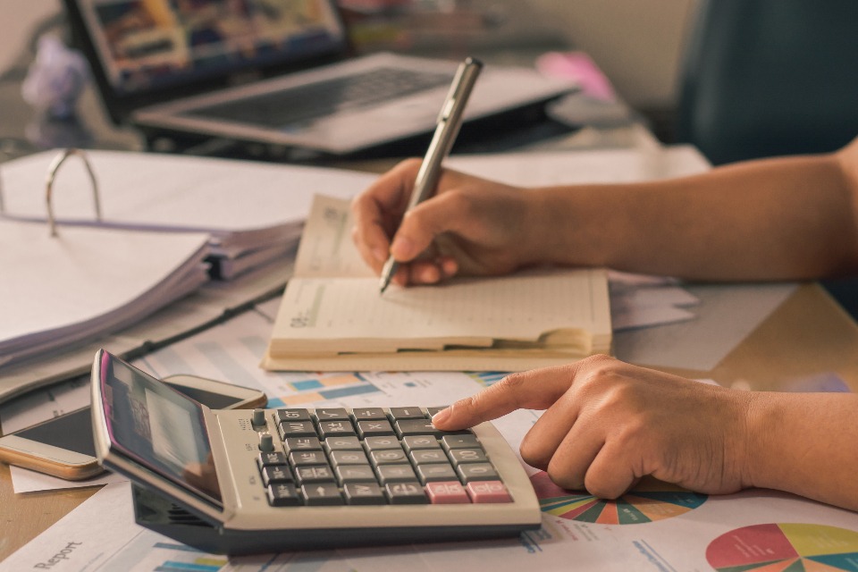 How to Lock In a Mortgage Rate Desk calendar beside a small house model and mortgage paperwork